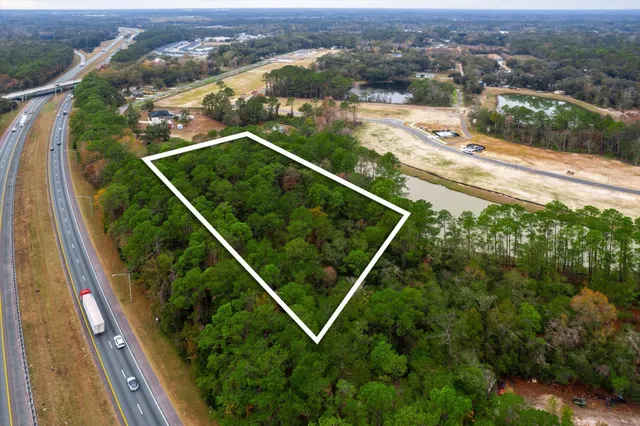 an aerial view of residential houses with yard
