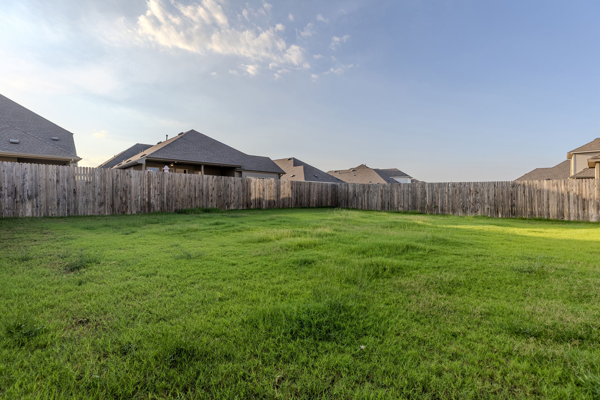 13720 Jon Ryan Road Manor, TX 78653 - Photo 28 of 31 A spacious backyard with mature wood fencing offers privacy and ample green space.