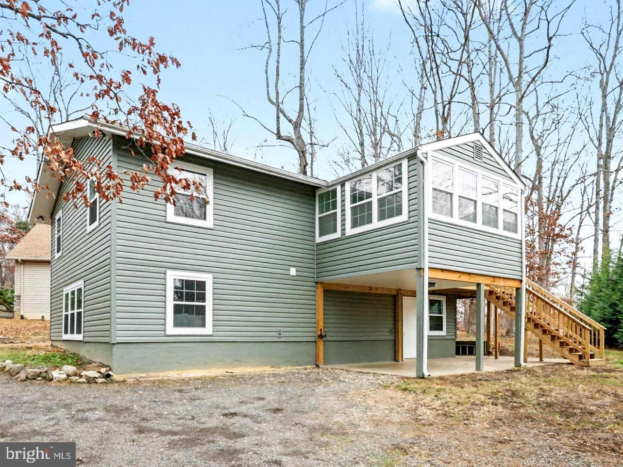 305 Green Street Locust Grove, VA 22508 - Photo 22 of 25 a front view of a house with a yard and garage