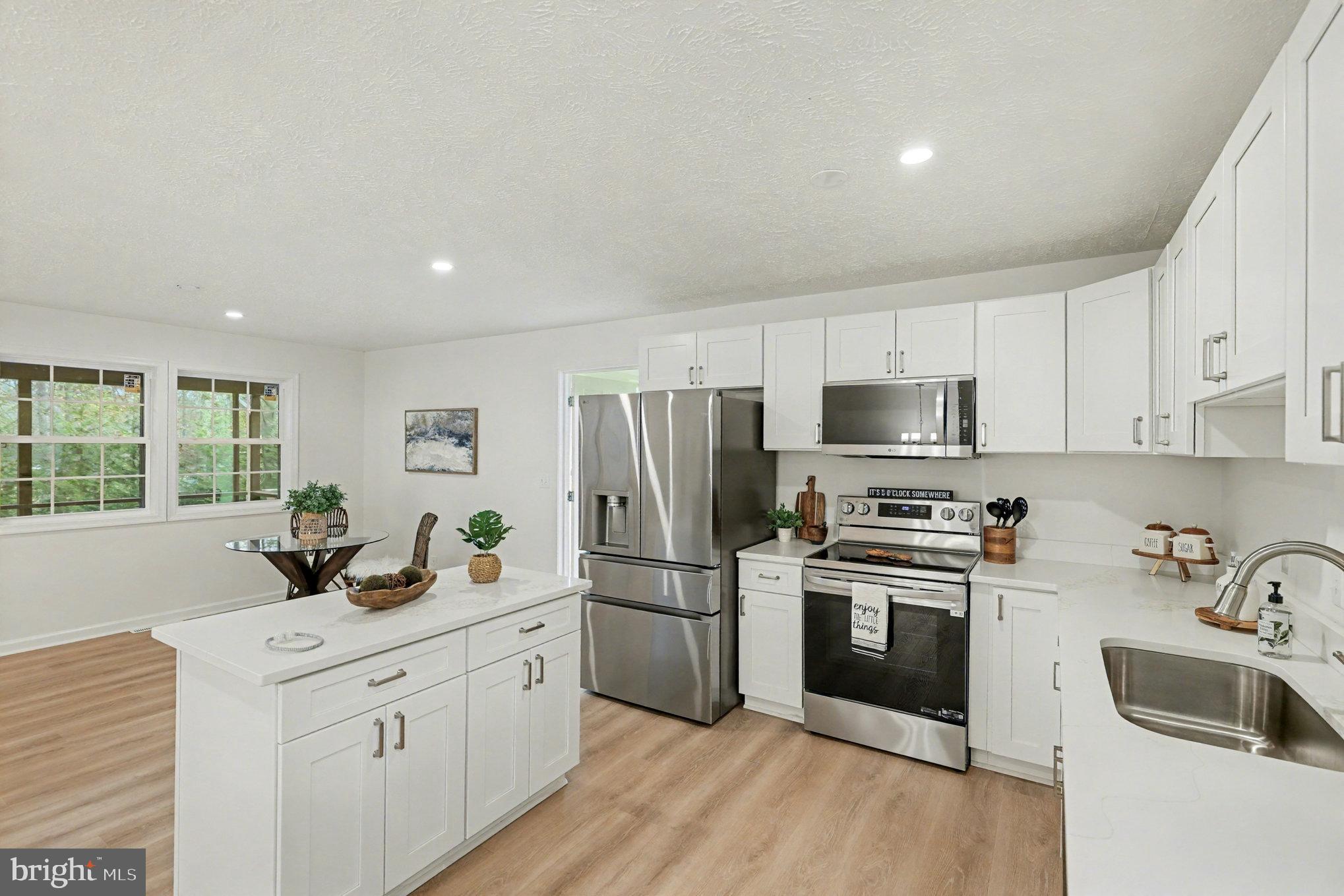 305 Green Street Locust Grove, VA 22508 - Photo 9 of 25 a kitchen with granite countertop a sink stainless steel appliances and window
