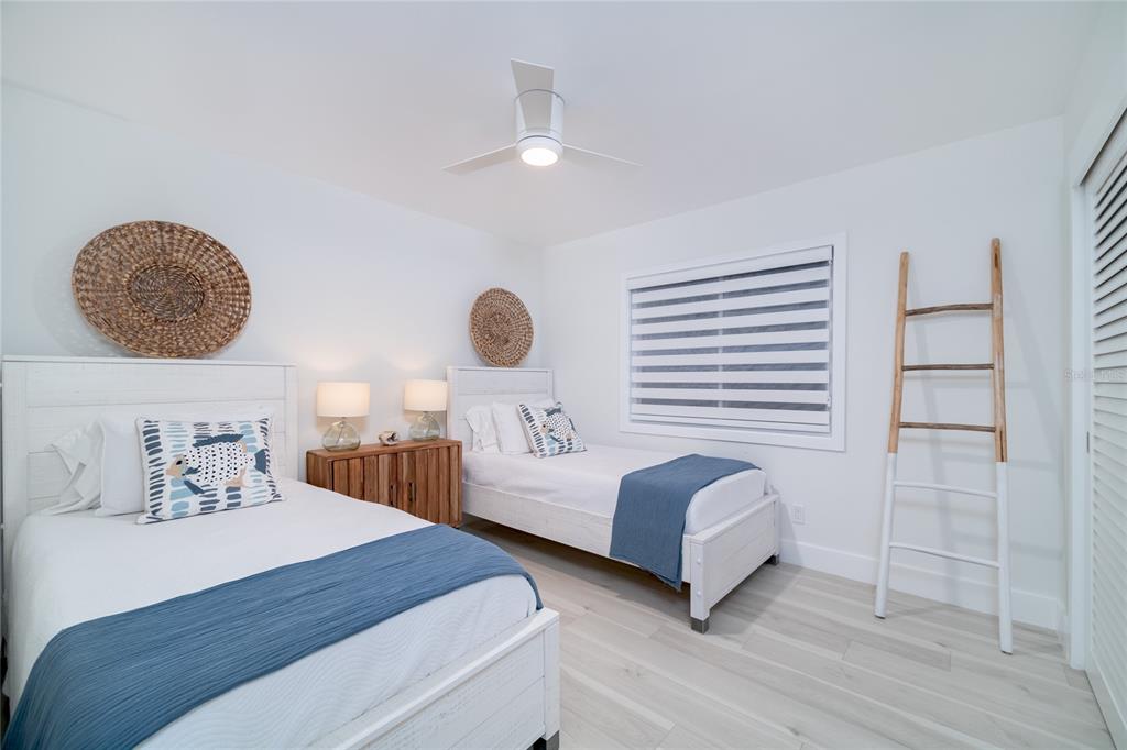 1104 Beach Trail, Unit 1 Indian Rocks Beach, FL 33785 - Photo 13 of 24 a bedroom with two beds and painting on the wall