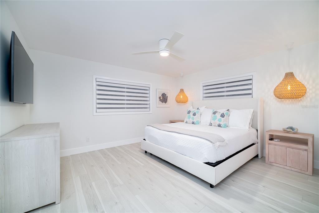 1104 Beach Trail, Unit 1 Indian Rocks Beach, FL 33785 - Photo 14 of 24 a bedroom with a bed and a flat screen tv