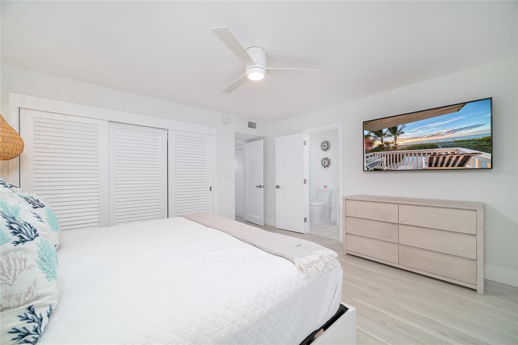 1104 Beach Trail, Unit 1 Indian Rocks Beach, FL 33785 - Photo 16 of 24 a bedroom with a bed and a dresser