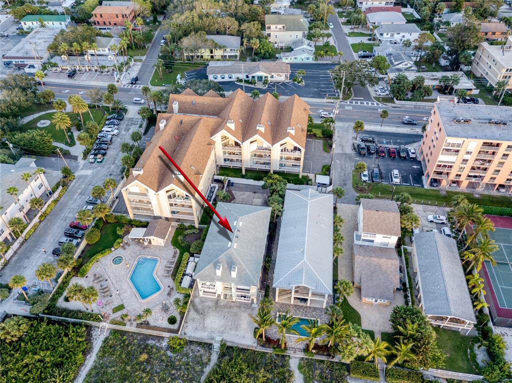 1104 Beach Trail, Unit 1 Indian Rocks Beach, FL 33785 - Photo 20 of 24 an aerial view of a house with a swimming pool outdoor seating and yard