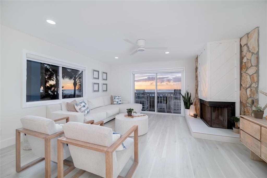 1104 Beach Trail, Unit 1 Indian Rocks Beach, FL 33785 - Photo 4 of 24 a living room with furniture a fireplace and a flat screen tv