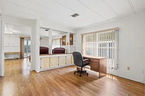a living room with furniture a couch and wooden floor