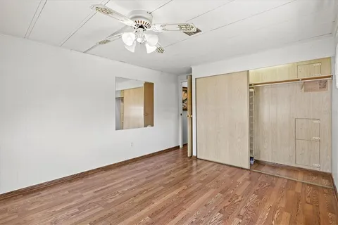 a bedroom with a bed and a flat tv screen