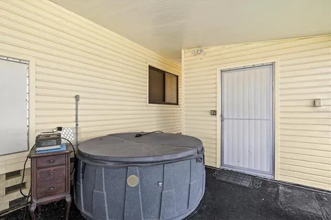 a view of a house with backyard and sitting area