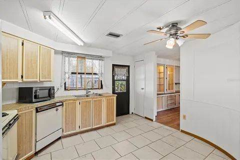 a kitchen with stainless steel appliances granite countertop a sink cabinets and a refrigerator