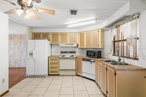 a kitchen with granite countertop appliances cabinets and a sink