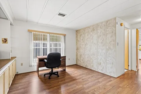 a living room with furniture a ceiling fan and a rug