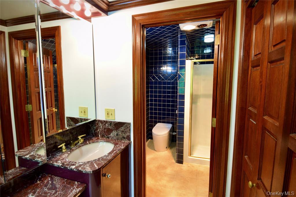 285 Goff Road Livingston Manor, NY 12758 - Photo 19 of 24 Full bathroom featuring vanity,light tile patterned flooring, ashower stall, and ornamentalmolding
