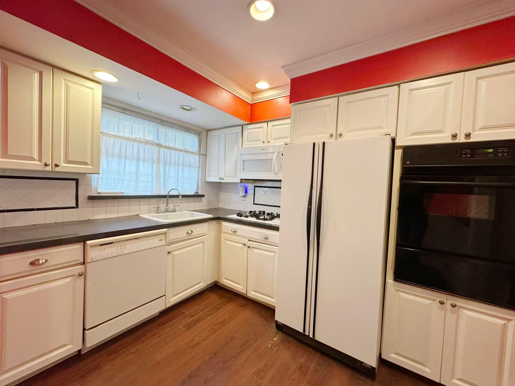 23-11 Whitestone Expressway Queens, NY 11357 - Photo 2 of 10 a kitchen with stainless steel appliances a refrigerator sink and cabinets