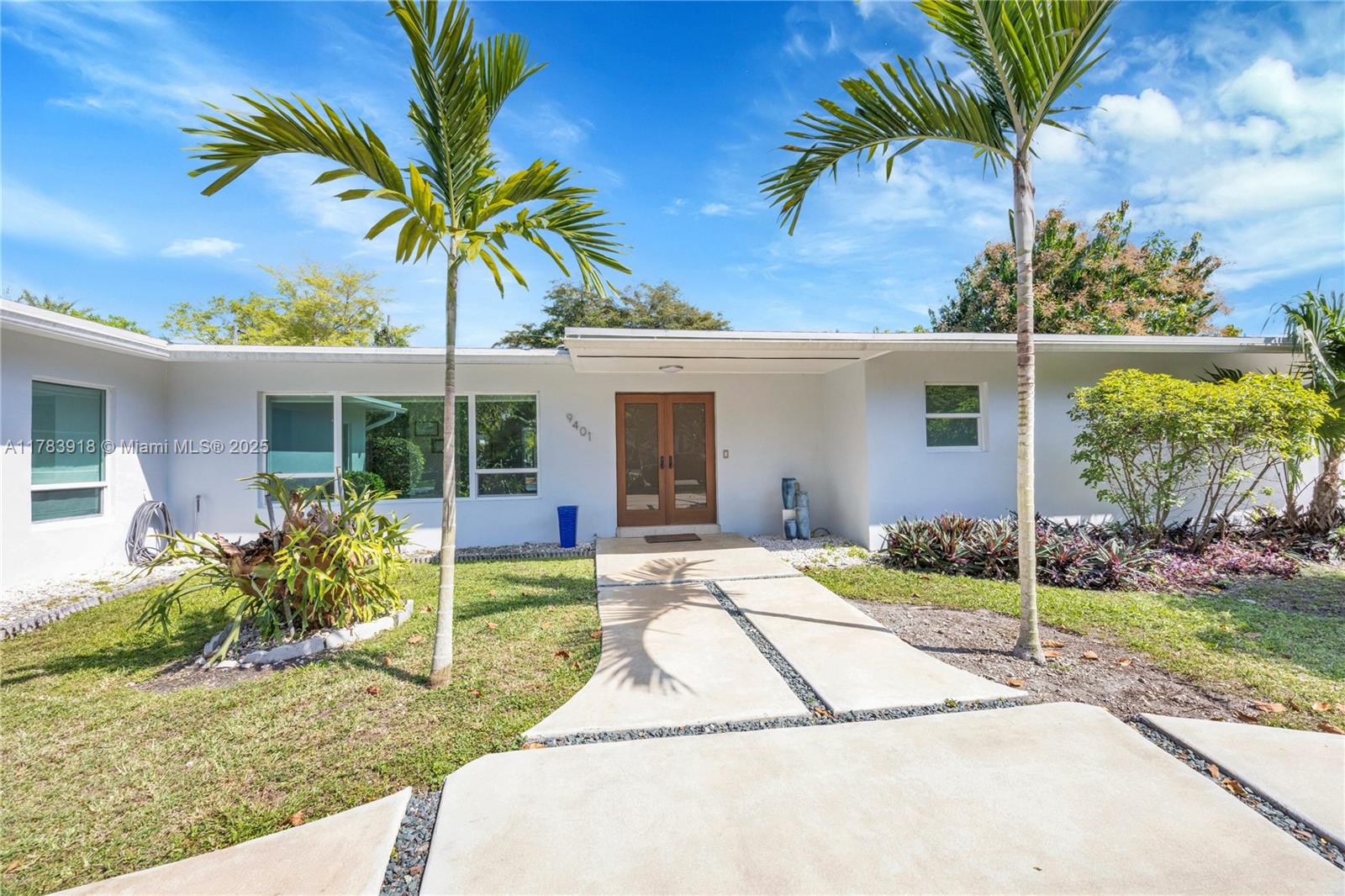 9401 Southwest 69th Court Pinecrest, FL 33156 - Photo 1 of 39 a house with a garden and pathway