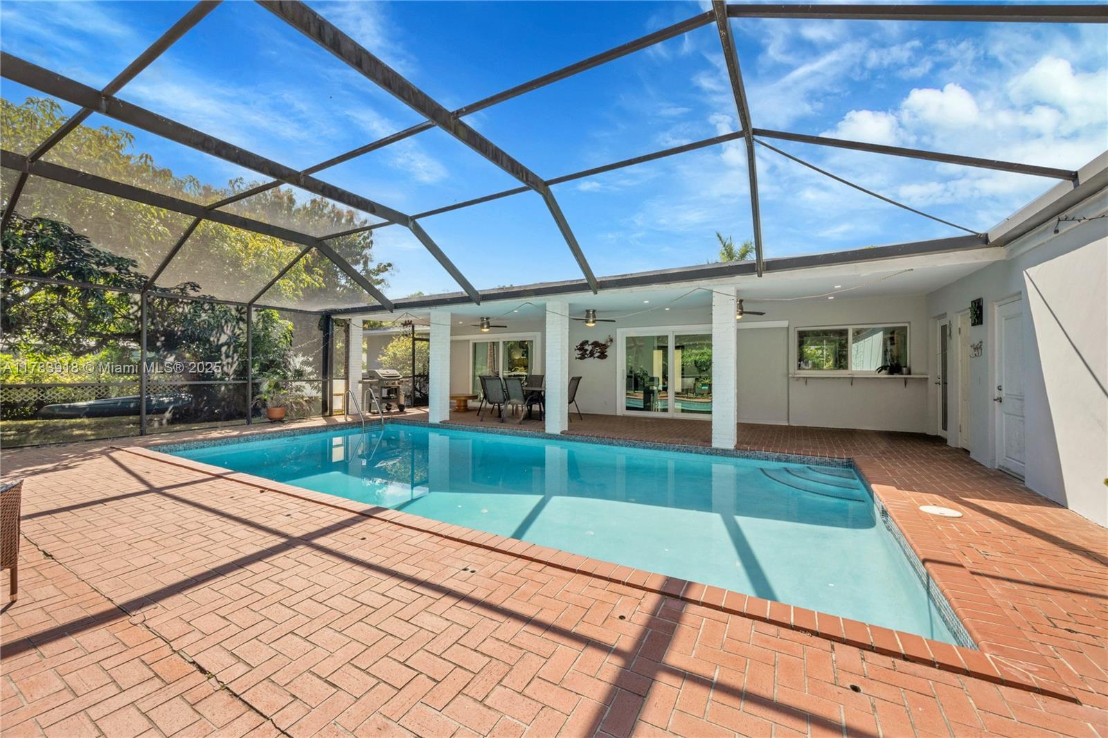 9401 Southwest 69th Court Pinecrest, FL 33156 - Photo 15 of 39 a view of swimming pool with a backyard