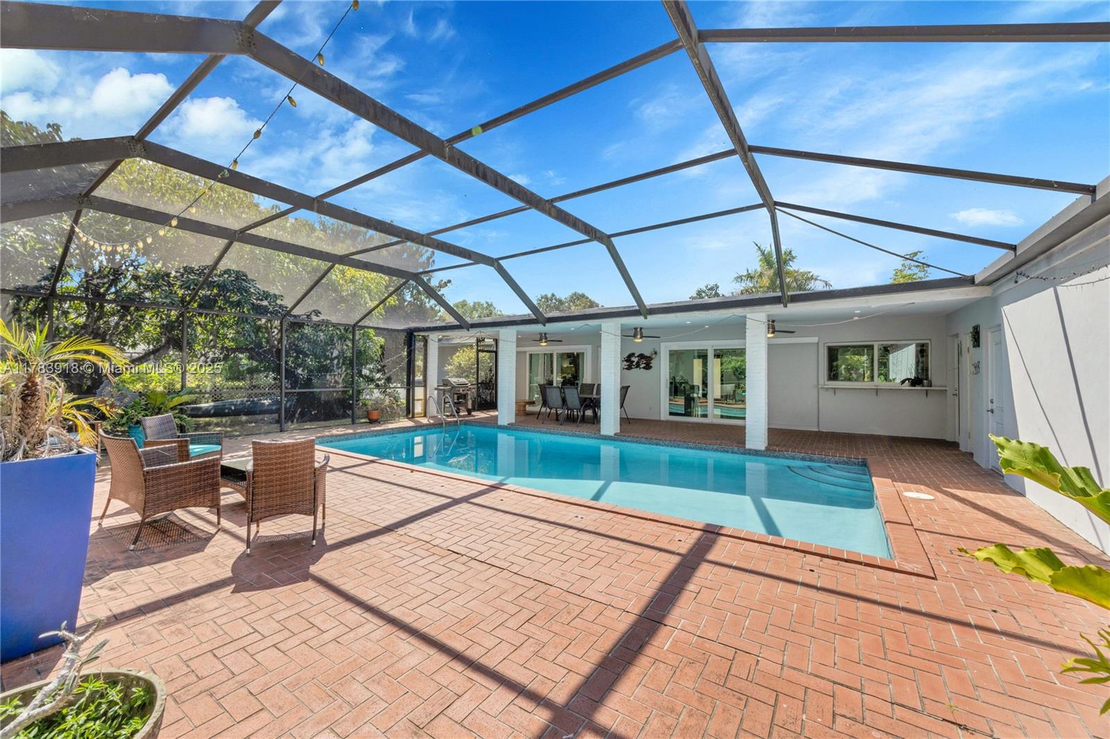 9401 Southwest 69th Court Pinecrest, FL 33156 - Photo 16 of 39 a view of a patio with table and chairs and wooden floor