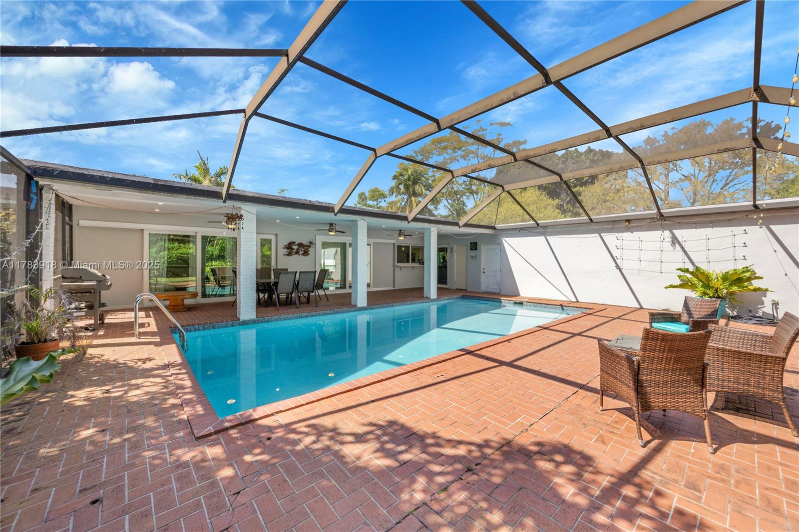 9401 Southwest 69th Court Pinecrest, FL 33156 - Photo 17 of 39 a view of a backyard with furniture and floor to ceiling window