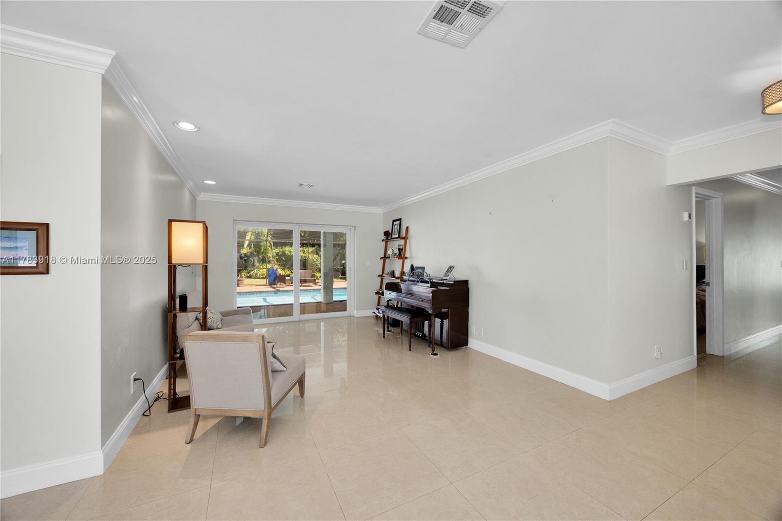 9401 Southwest 69th Court Pinecrest, FL 33156 - Photo 20 of 39 a living room with furniture and a dining table with garden view