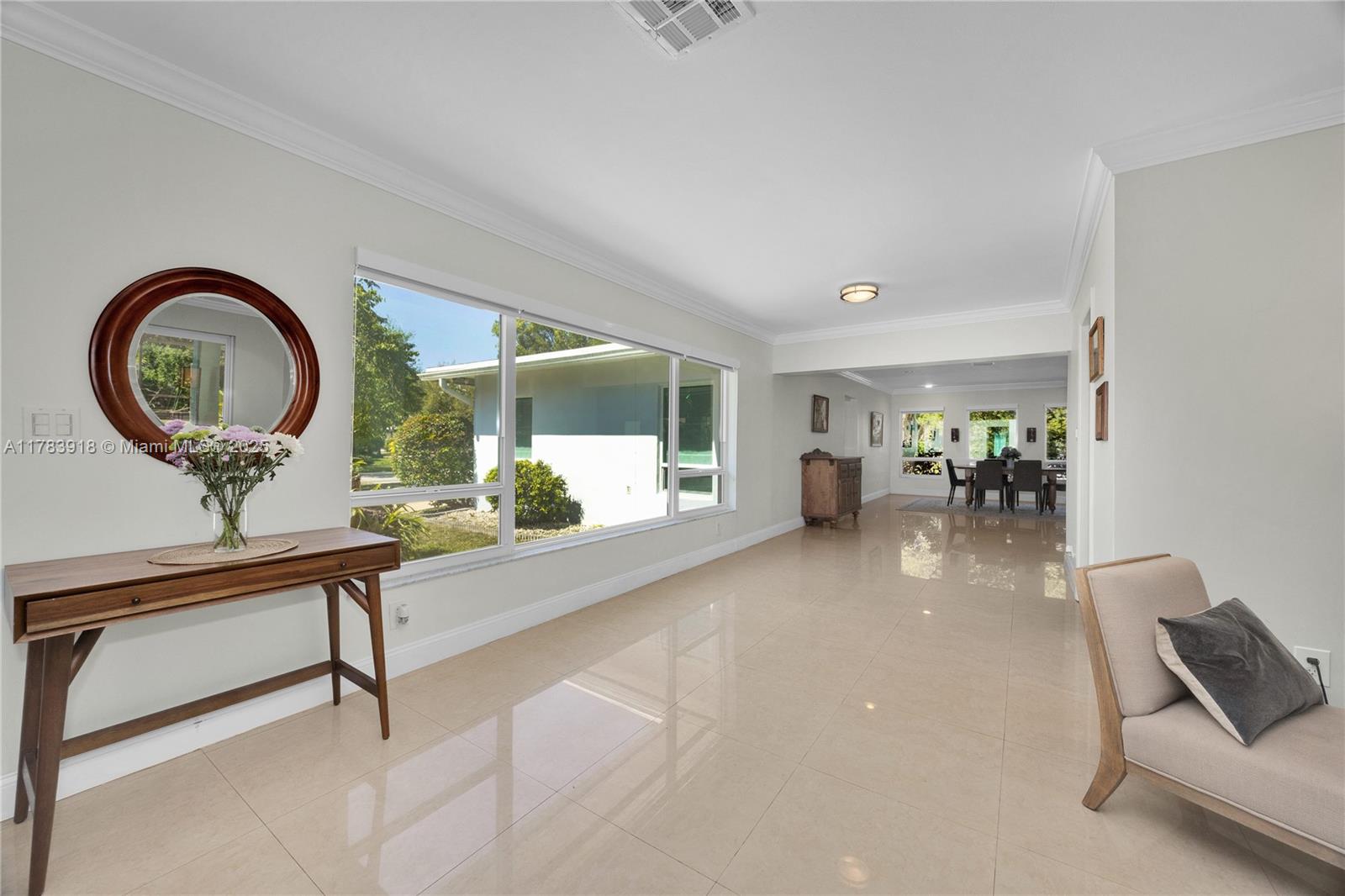 9401 Southwest 69th Court Pinecrest, FL 33156 - Photo 23 of 39 a living room with furniture a table and a large window