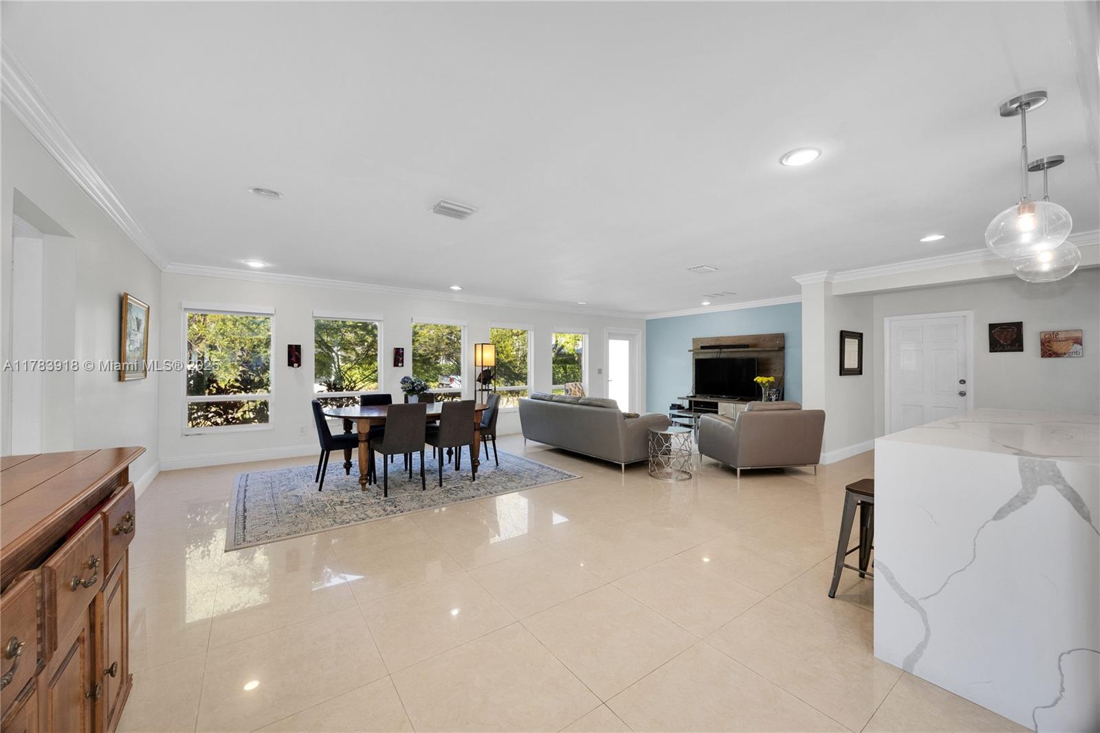 9401 Southwest 69th Court Pinecrest, FL 33156 - Photo 24 of 39 a living room with furniture and a table