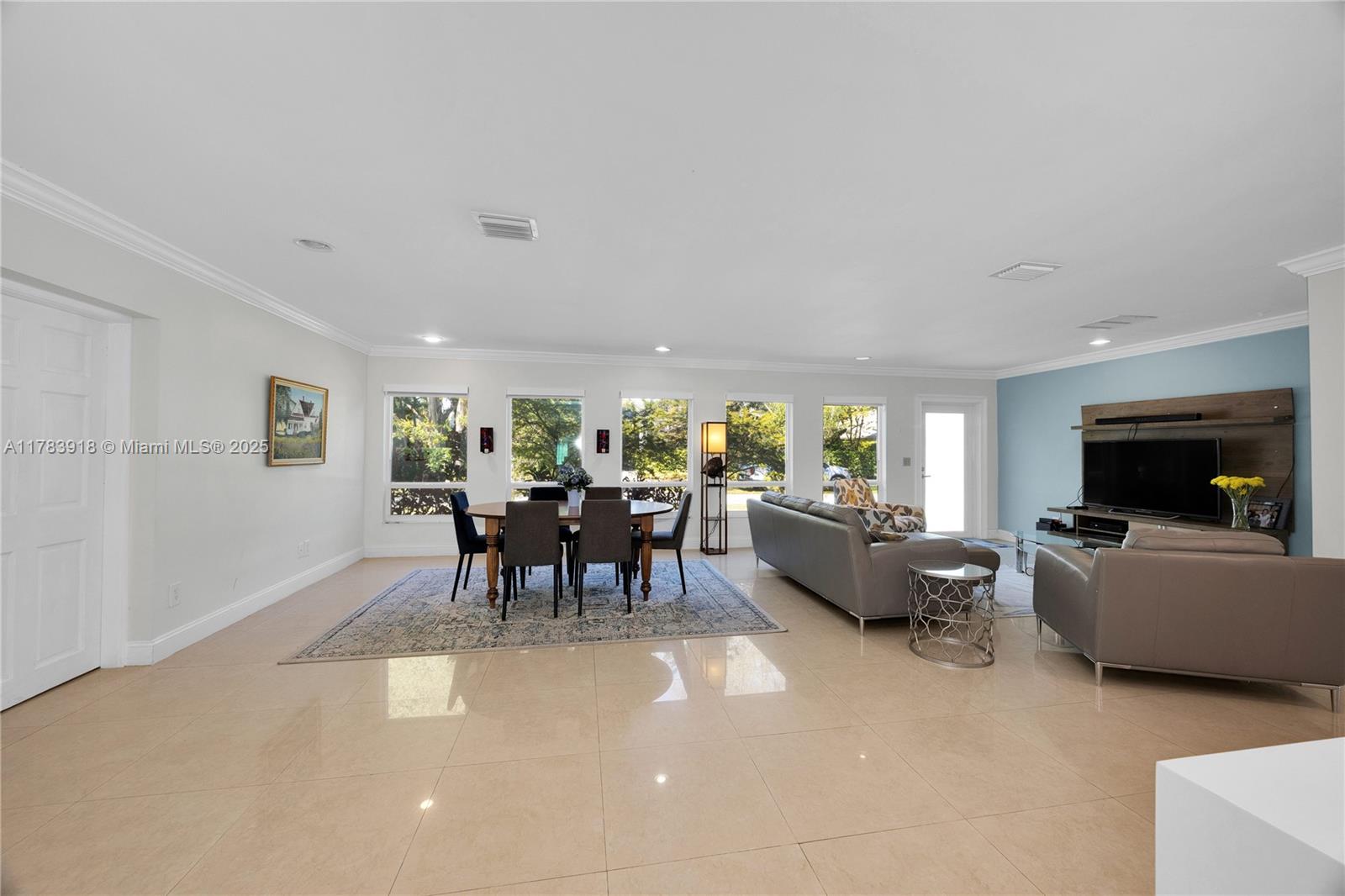 9401 Southwest 69th Court Pinecrest, FL 33156 - Photo 25 of 39 a living room with furniture and a flat screen tv