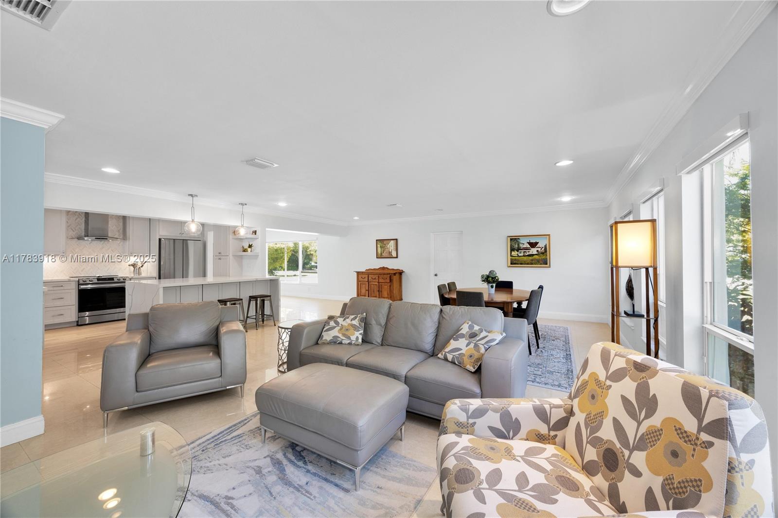 9401 Southwest 69th Court Pinecrest, FL 33156 - Photo 27 of 39 a living room with furniture and a large window