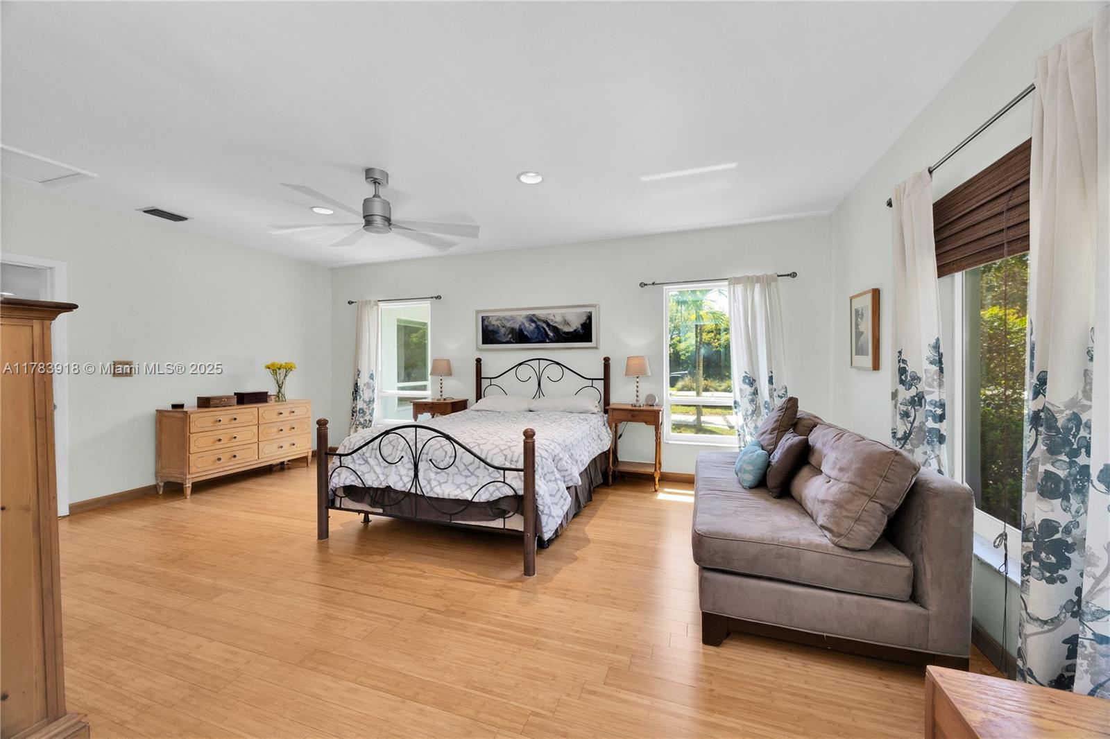 9401 Southwest 69th Court Pinecrest, FL 33156 - Photo 33 of 39 a spacious bedroom with a bed couch and a window