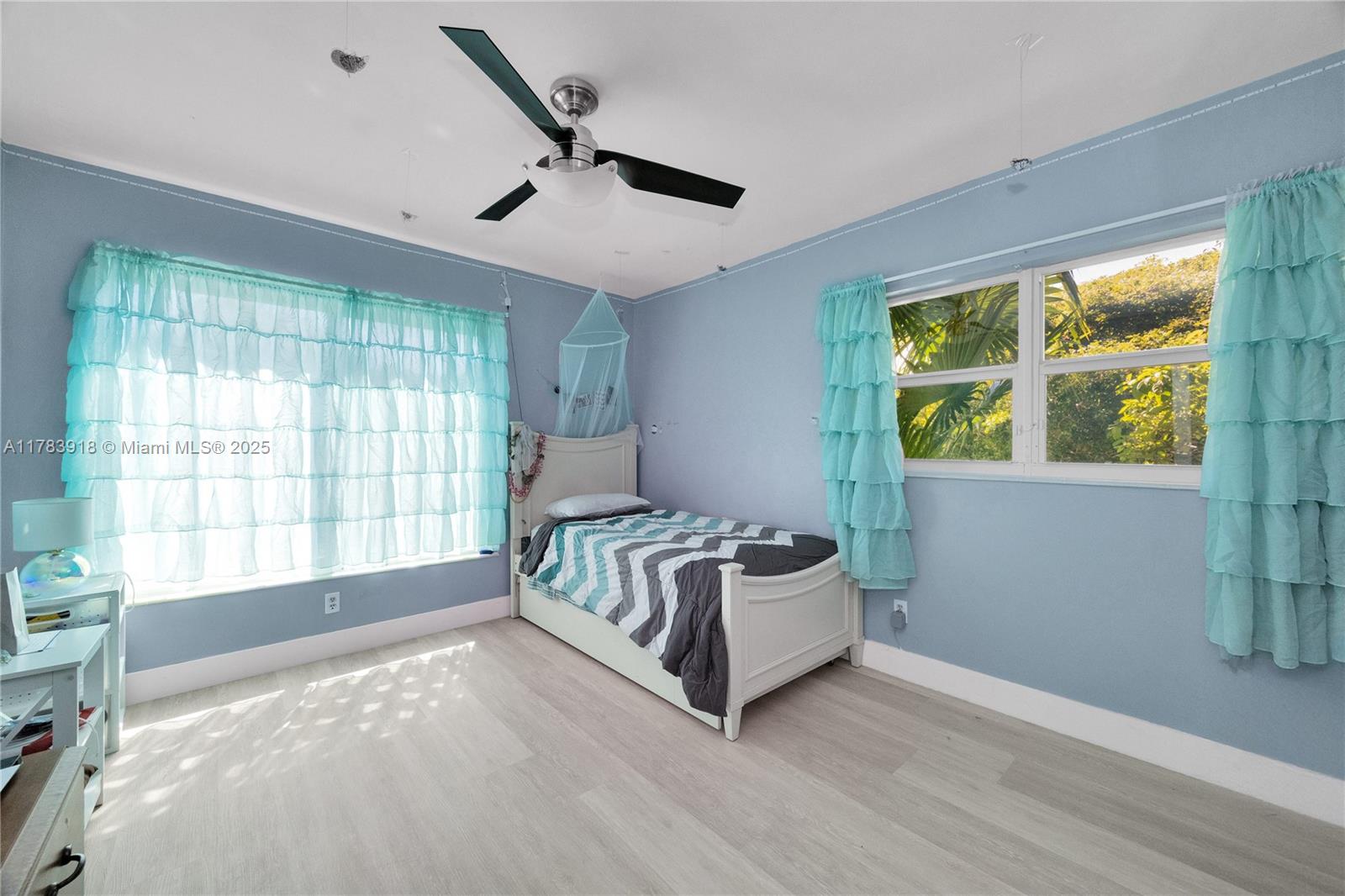9401 Southwest 69th Court Pinecrest, FL 33156 - Photo 37 of 39 a spacious bedroom with a large bed and a large window