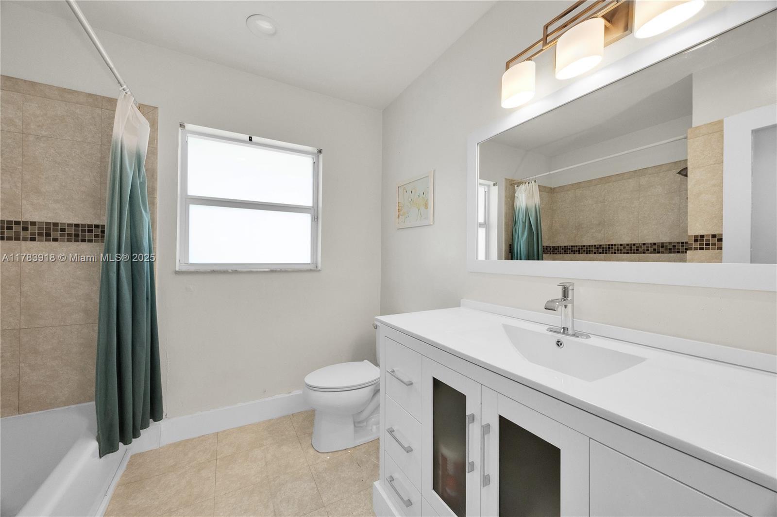 9401 Southwest 69th Court Pinecrest, FL 33156 - Photo 38 of 39 a spacious bathroom with a sink toilet and mirror