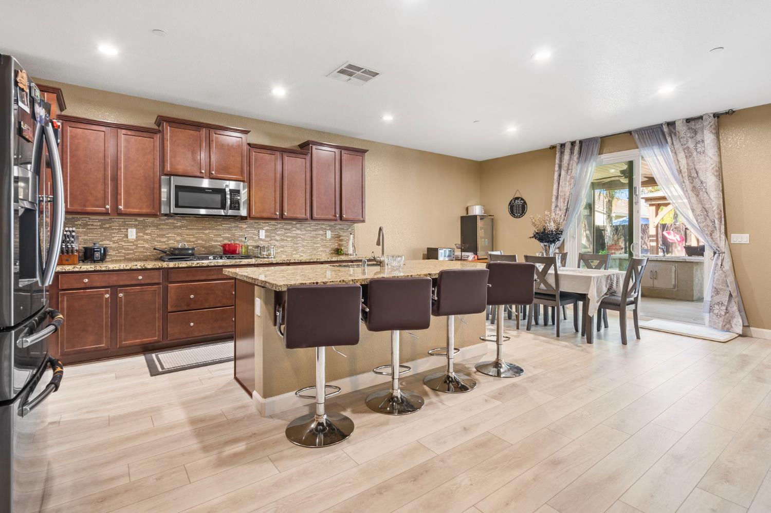 2317 Mathar Drive Manteca, CA 95337 - Photo 14 of 48 a kitchen with stainless steel appliances kitchen island granite countertop a sink and cabinets