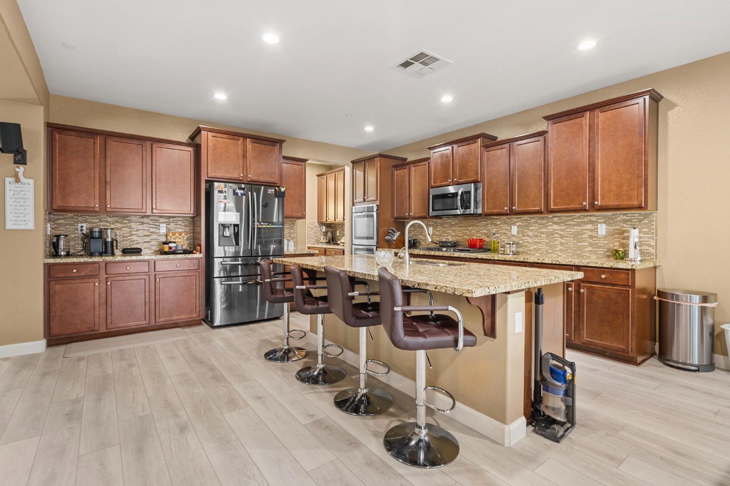 2317 Mathar Drive Manteca, CA 95337 - Photo 20 of 48 a kitchen with stainless steel appliances a stove a sink a refrigerator and cabinets