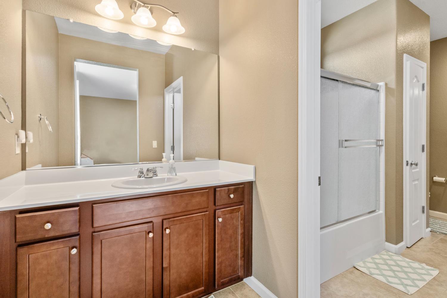 2317 Mathar Drive Manteca, CA 95337 - Photo 27 of 48 a bathroom with a sink a vanity and a mirror
