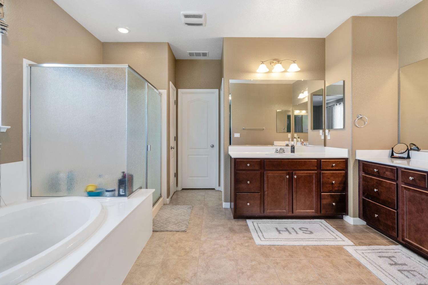 2317 Mathar Drive Manteca, CA 95337 - Photo 32 of 48 a spacious bathroom with a tub sink and mirror