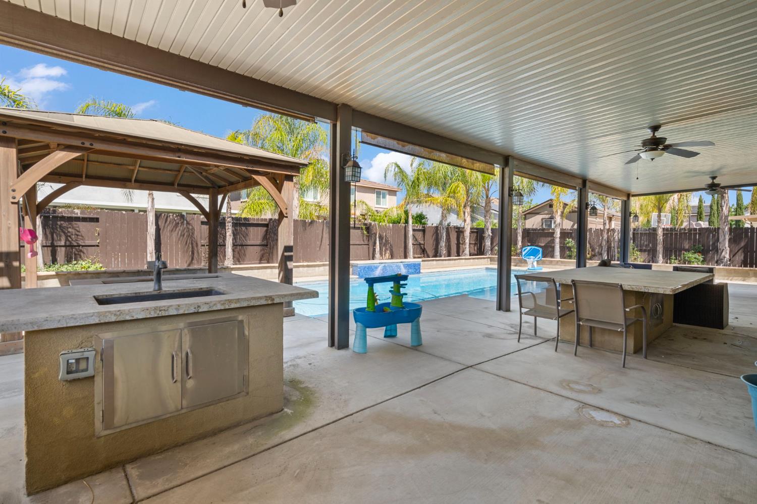2317 Mathar Drive Manteca, CA 95337 - Photo 42 of 48 a view of a kitchen with a sink and chairs