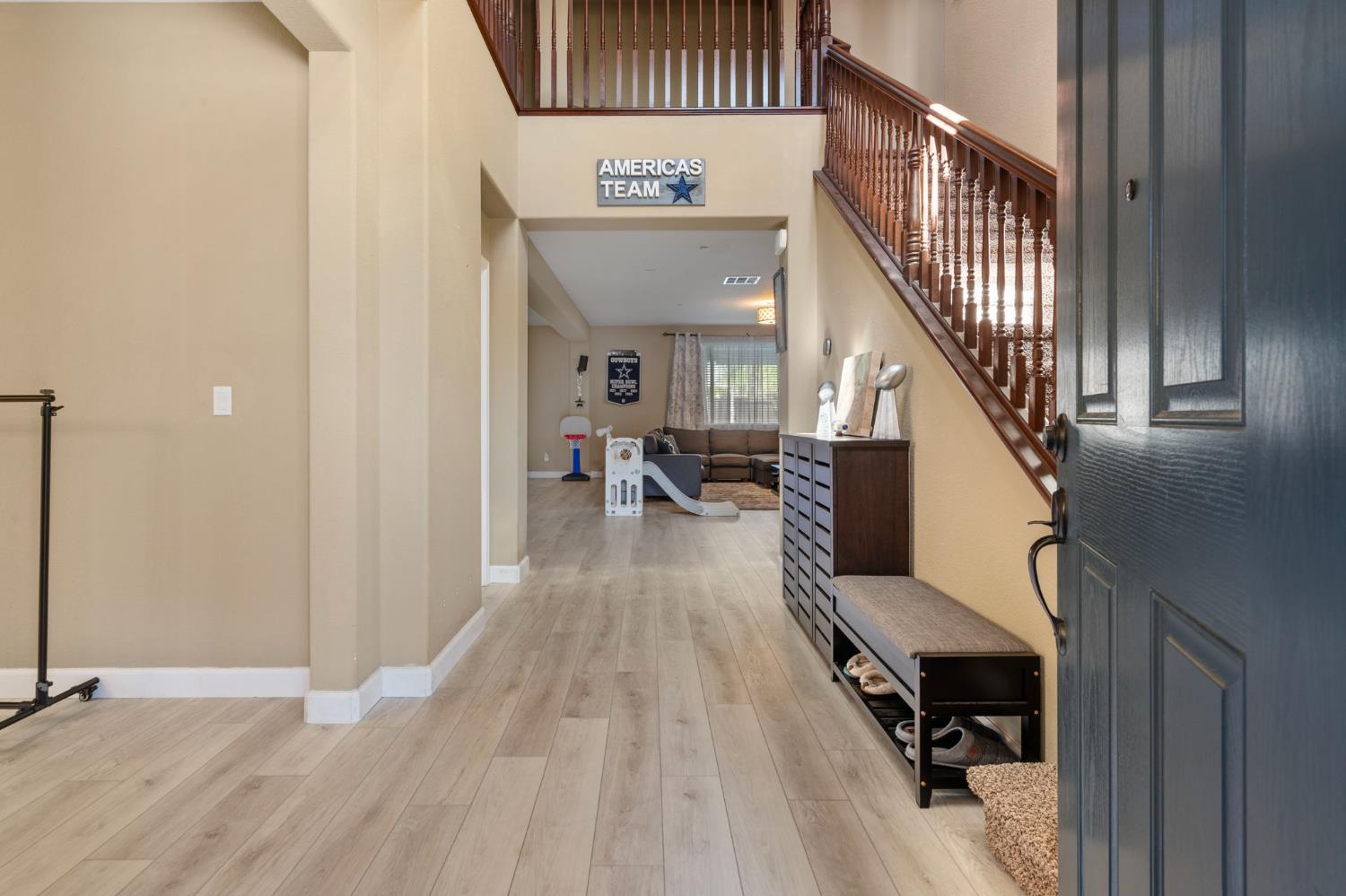 2317 Mathar Drive Manteca, CA 95337 - Photo 5 of 48 a view of a hallway with wooden floor and staircase