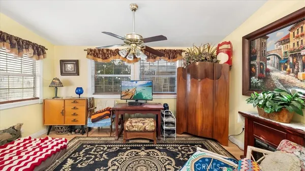 a bedroom with a bed a couch and dresser