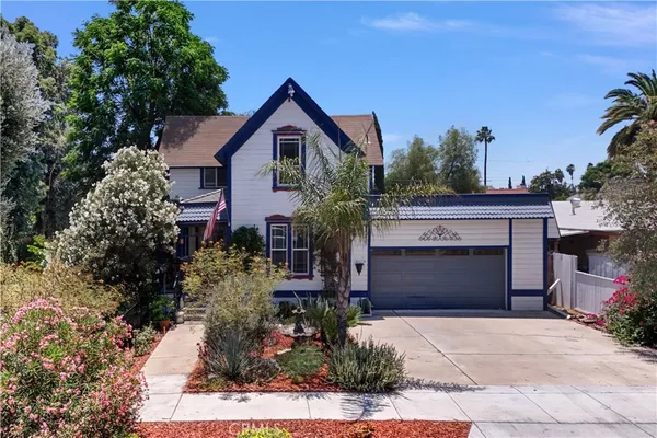 a front view of a house with a garden