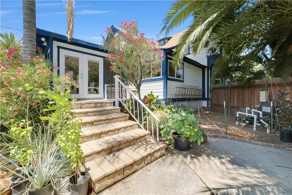 a view of backyard with outdoor seating and plants