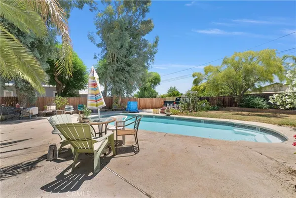 a swimming pool with outdoor seating and yard