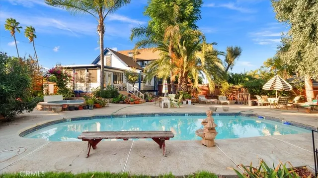 a swimming pool with outdoor seating and yard