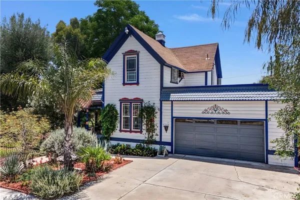 a front view of a house with a garden