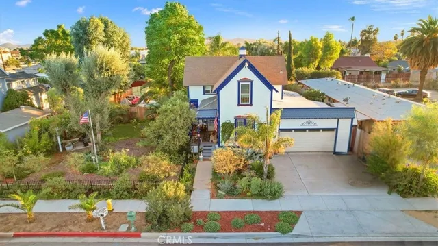 a view of a house with a yard and potted plants