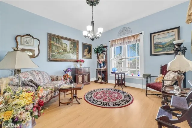 a living room with furniture a chandelier and a rug