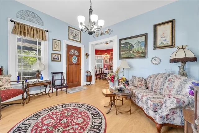 a view of a dining room with furniture and chandelier