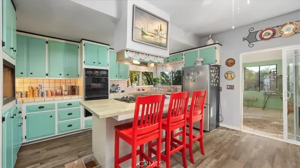 a dinning area with stainless steel appliances kitchen island granite countertop furniture and a fireplace