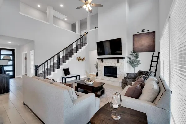 a living room with fireplace furniture and a flat screen tv