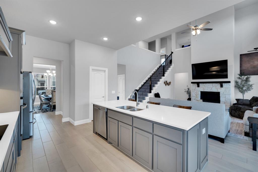 4605 Rambler Way Midlothian, TX 76065 - Photo 16 of 40 a kitchen with a sink a counter and cabinets
