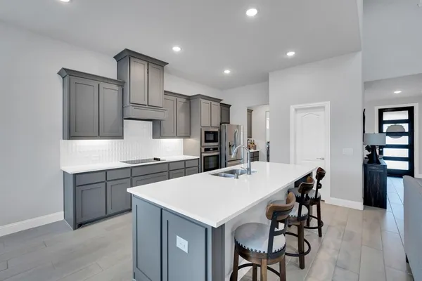 a kitchen that has a table and chairs in it