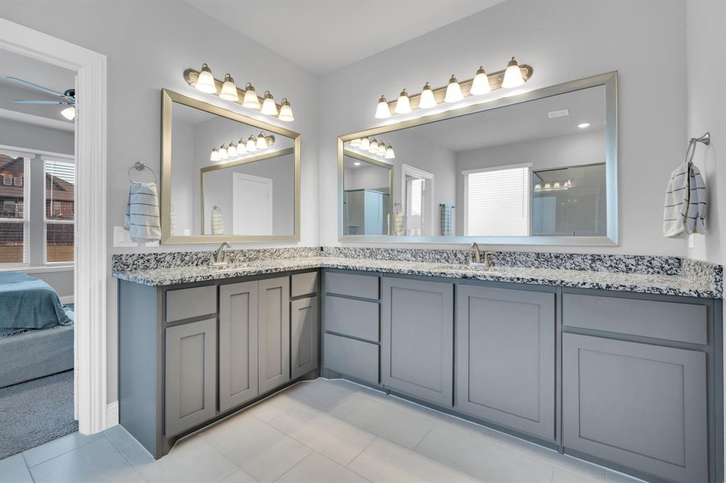 4605 Rambler Way Midlothian, TX 76065 - Photo 22 of 40 a bathroom with a granite countertop sink and a mirror