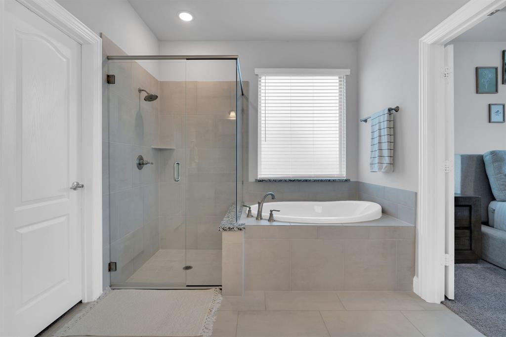 4605 Rambler Way Midlothian, TX 76065 - Photo 23 of 40 a bathroom with a bathtub and a shower